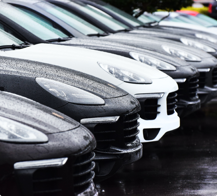 A line of parked Porsches