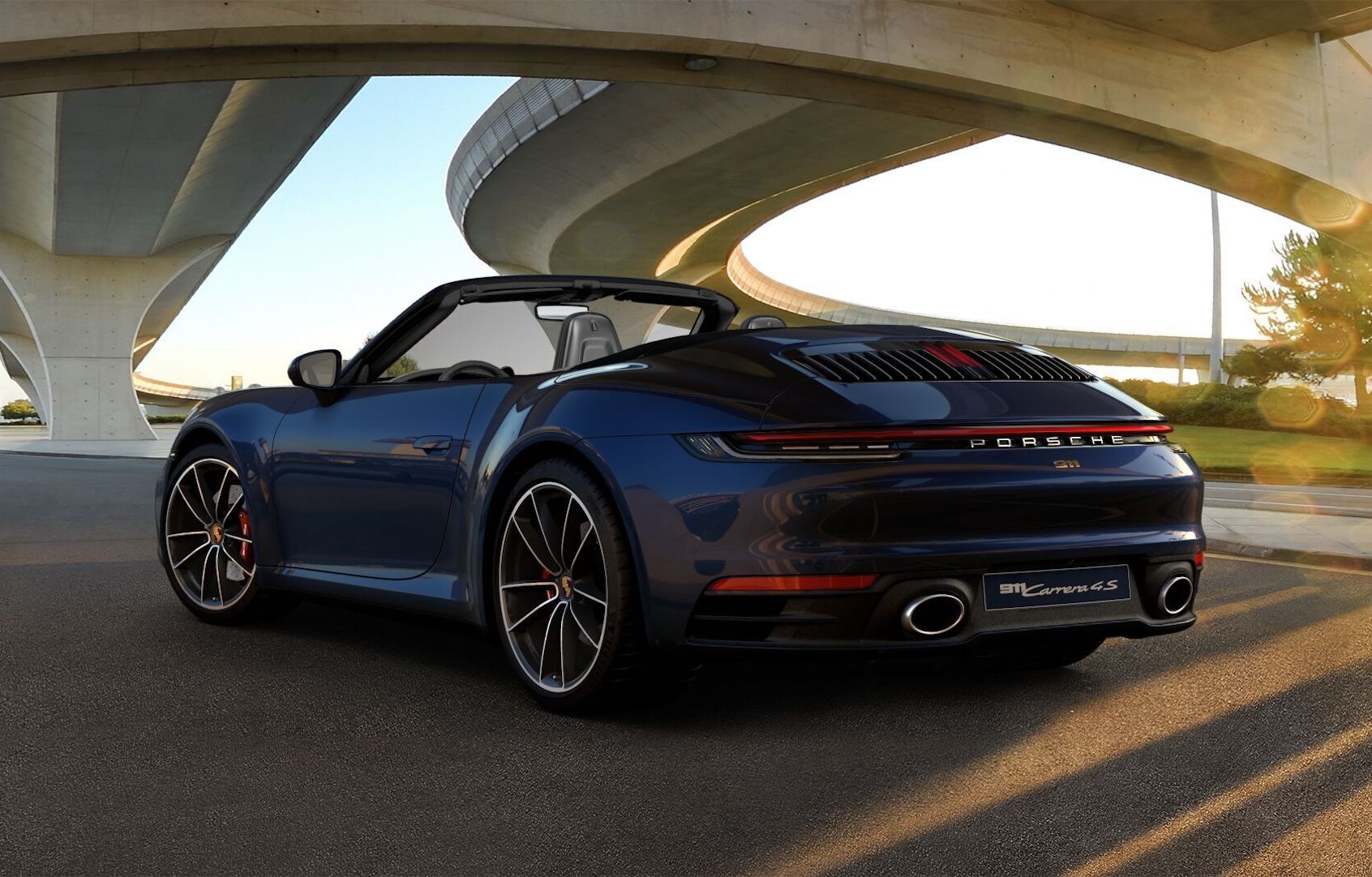 Porsche logo over a Porsche car